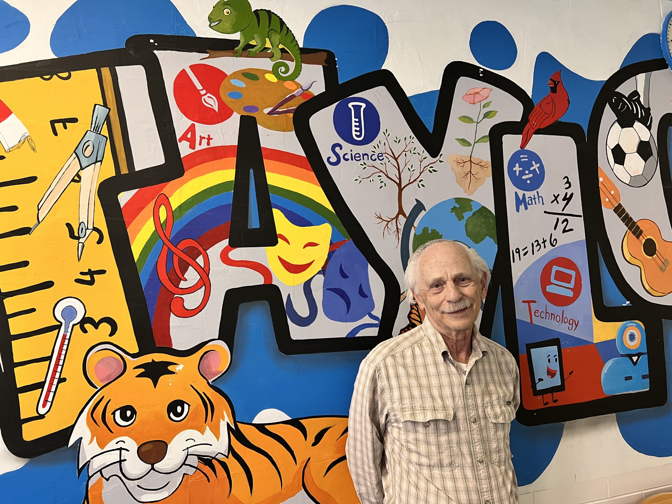 dr. A in front of a mural
